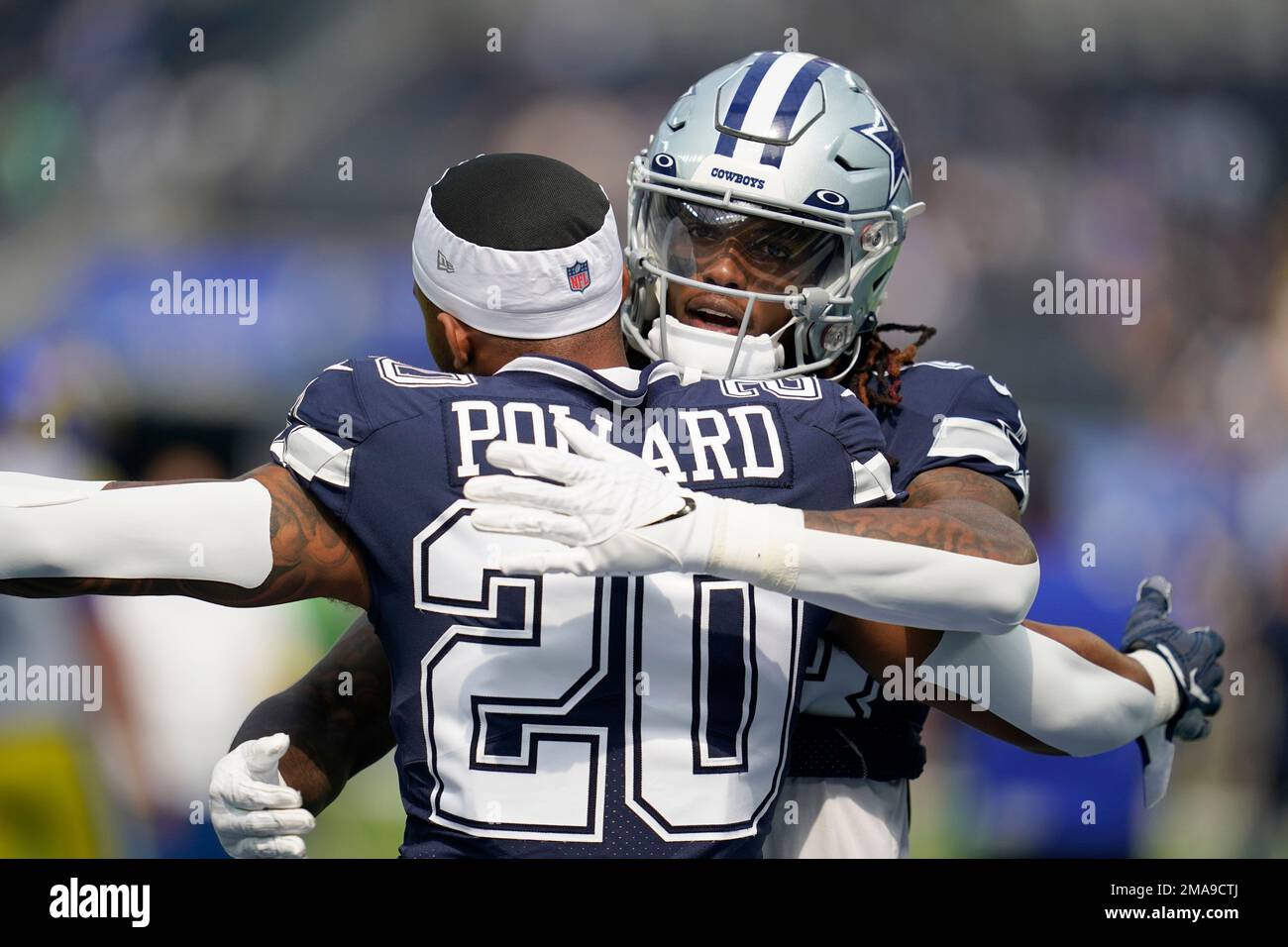 Dallas Cowboys running back Tony Pollard (20) and wide receiver CeeDee Lamb,  rear, greet each other during warmups before an NFL football game aginst  the Los Angeles Rams, Sunday, Oct. 9, 2022