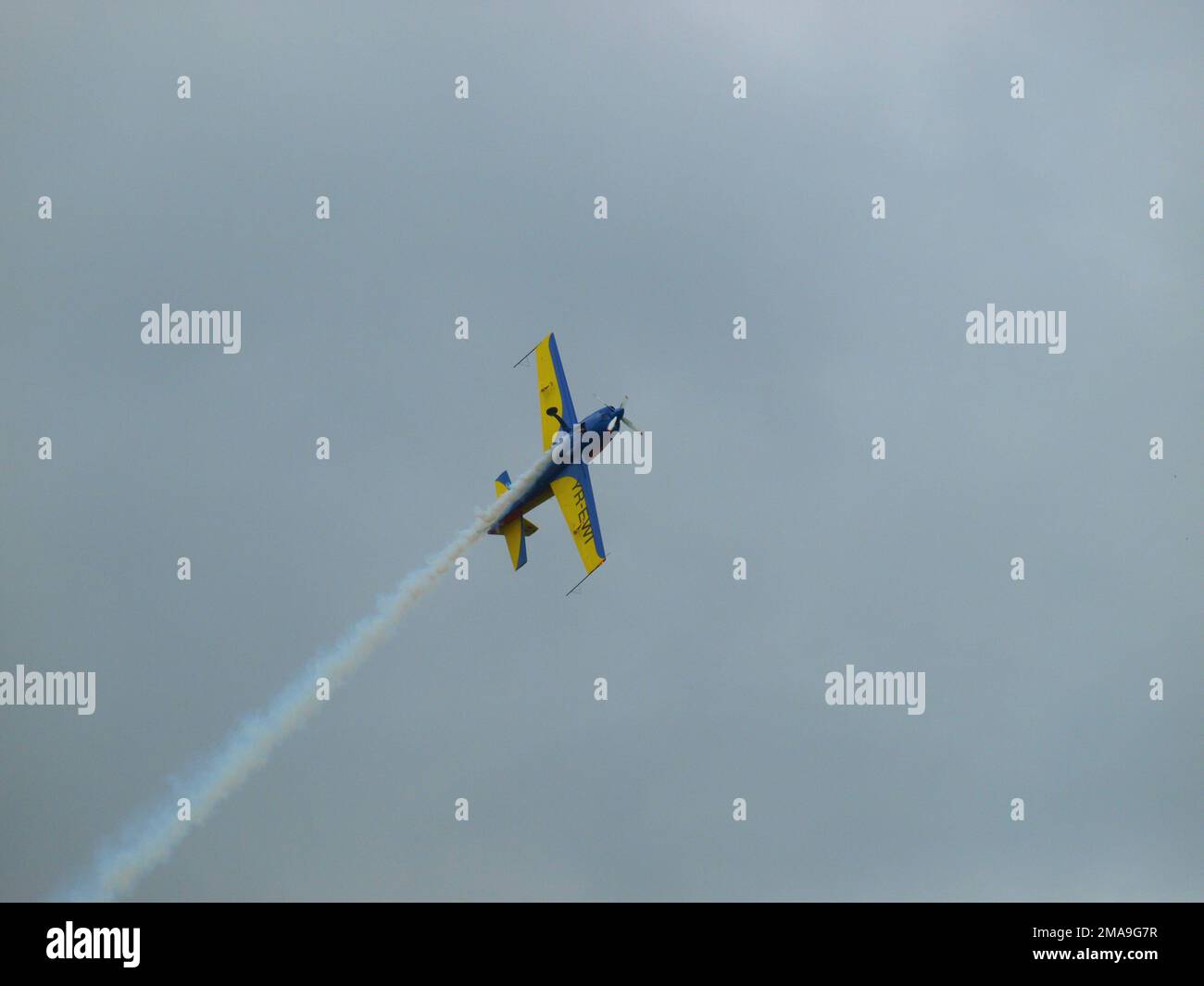 Light aircraft performing acrobatic aerobatic flying during air show with blue sky, on Strejnic airfield near Ploiesti, Romania Stock Photo
