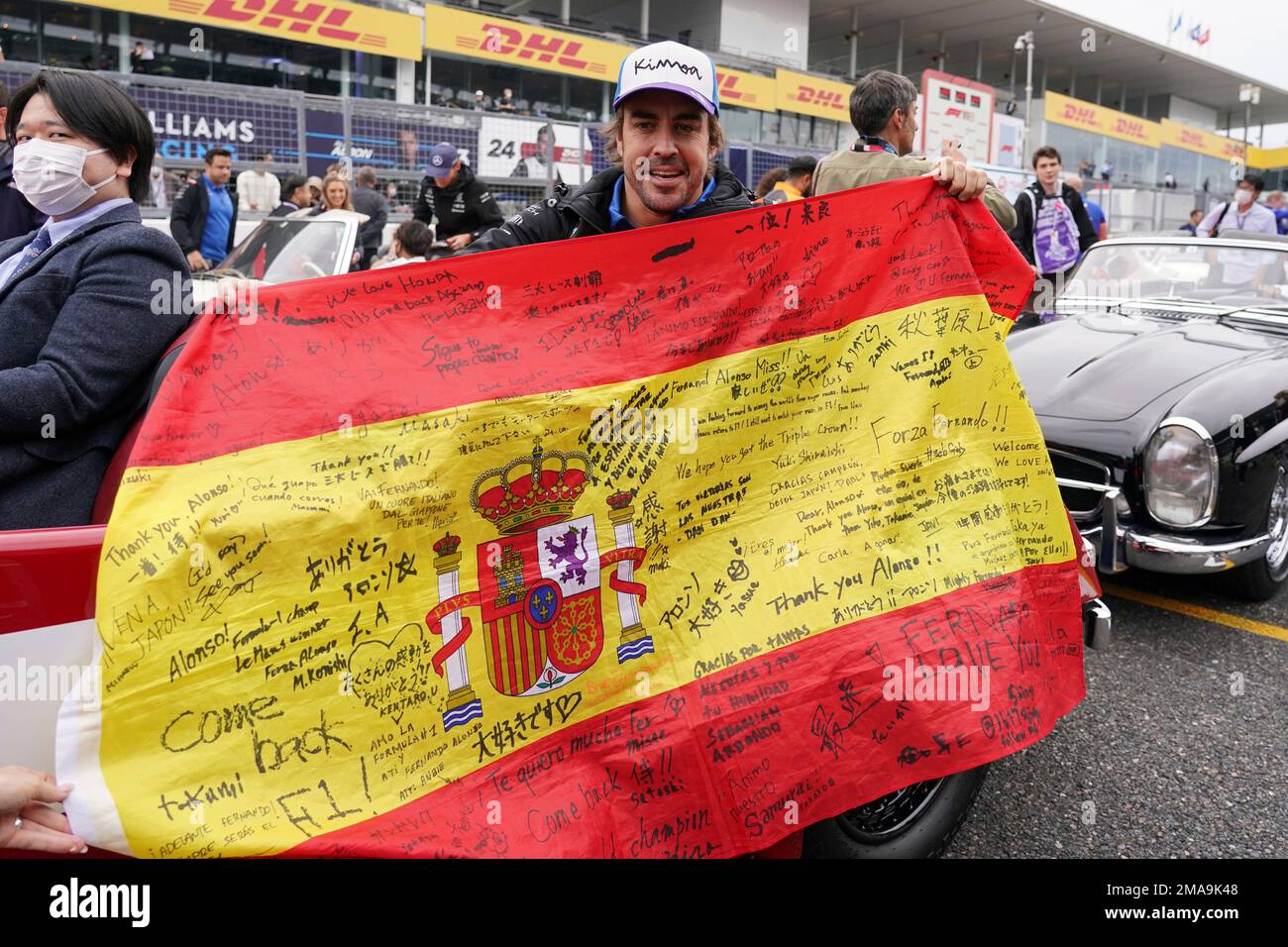 Alpine driver Fernando Alonso of Spain shows his national flag during ...