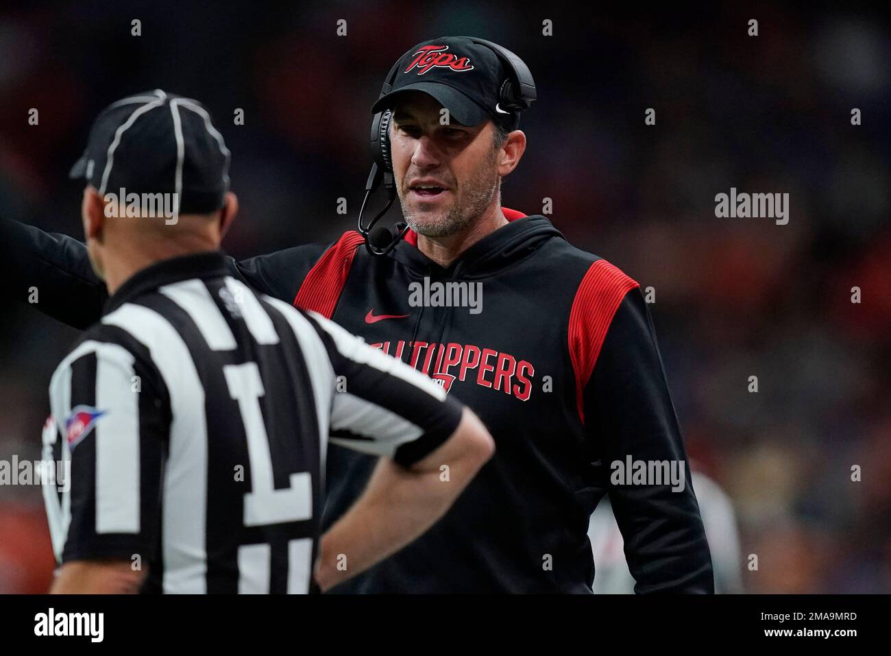 Western Kentucky head coach Tyson Helton, right, talks with an official