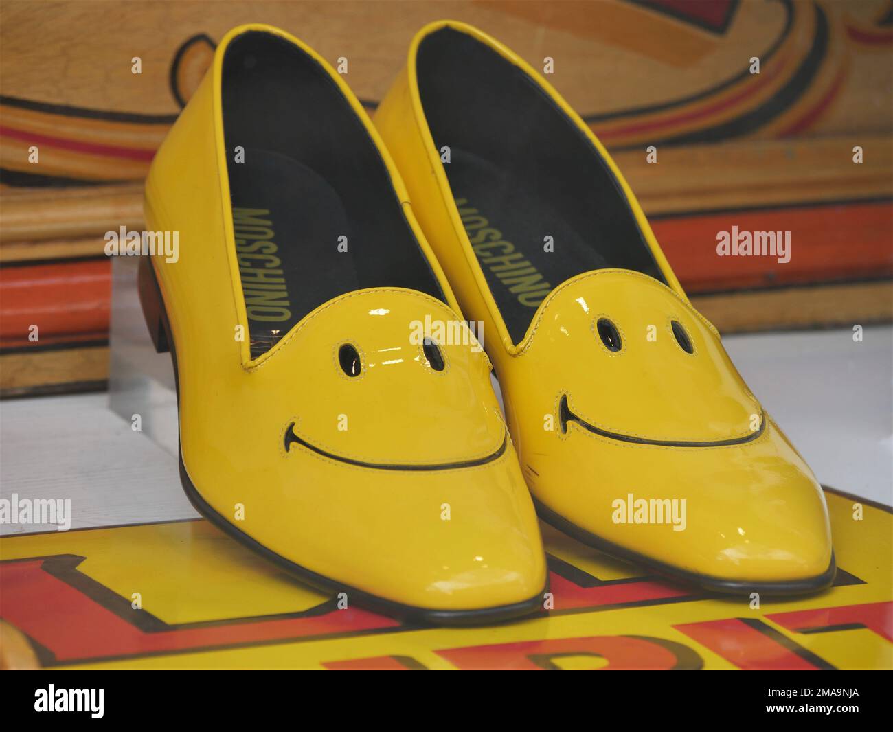 Shiny yellow smiley ladies shoes by Moschino Stock Photo