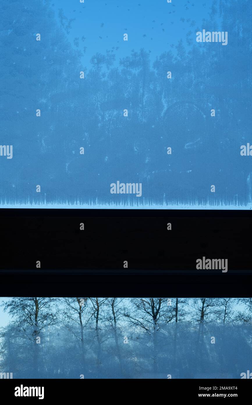Ice crystals formed on glass. A window from inside looking out. Stock Photo