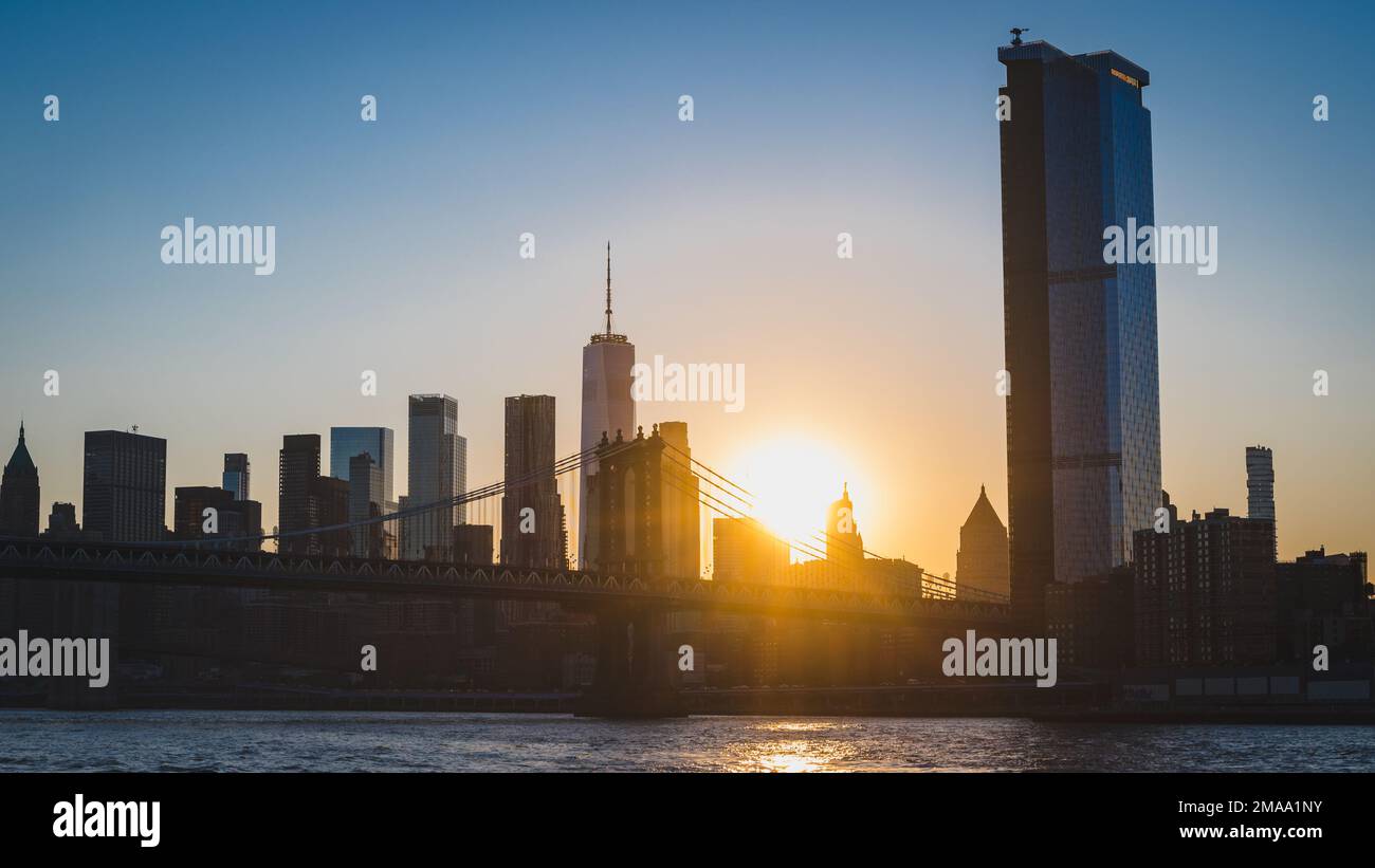 Sunset over Manhattan Bridge and Lowet Manhattan from East River Stock Photo