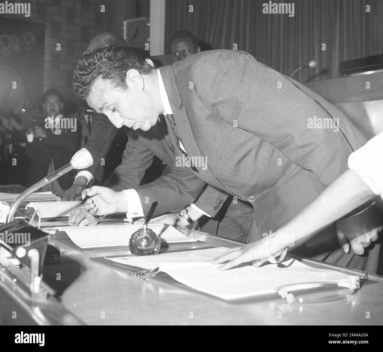 Ahmed Ben Bella, premier of Algeria, signs The African Charter, in