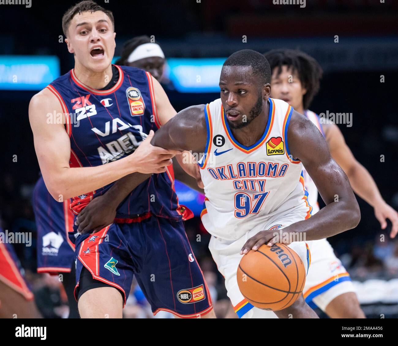 Oklahoma City Thunder's Eugene Omoruyi (97) goes against Adelaide 36ers' Hyrum Harris, left