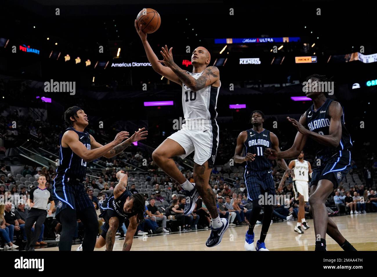 San Antonio Spurs forward Jeremy Sochan (10) drives to the basket against  Orlando Magic guard R.J. Hampton (13), center Mo Bamba (11) and center Bol  Bol, right, during the second half of