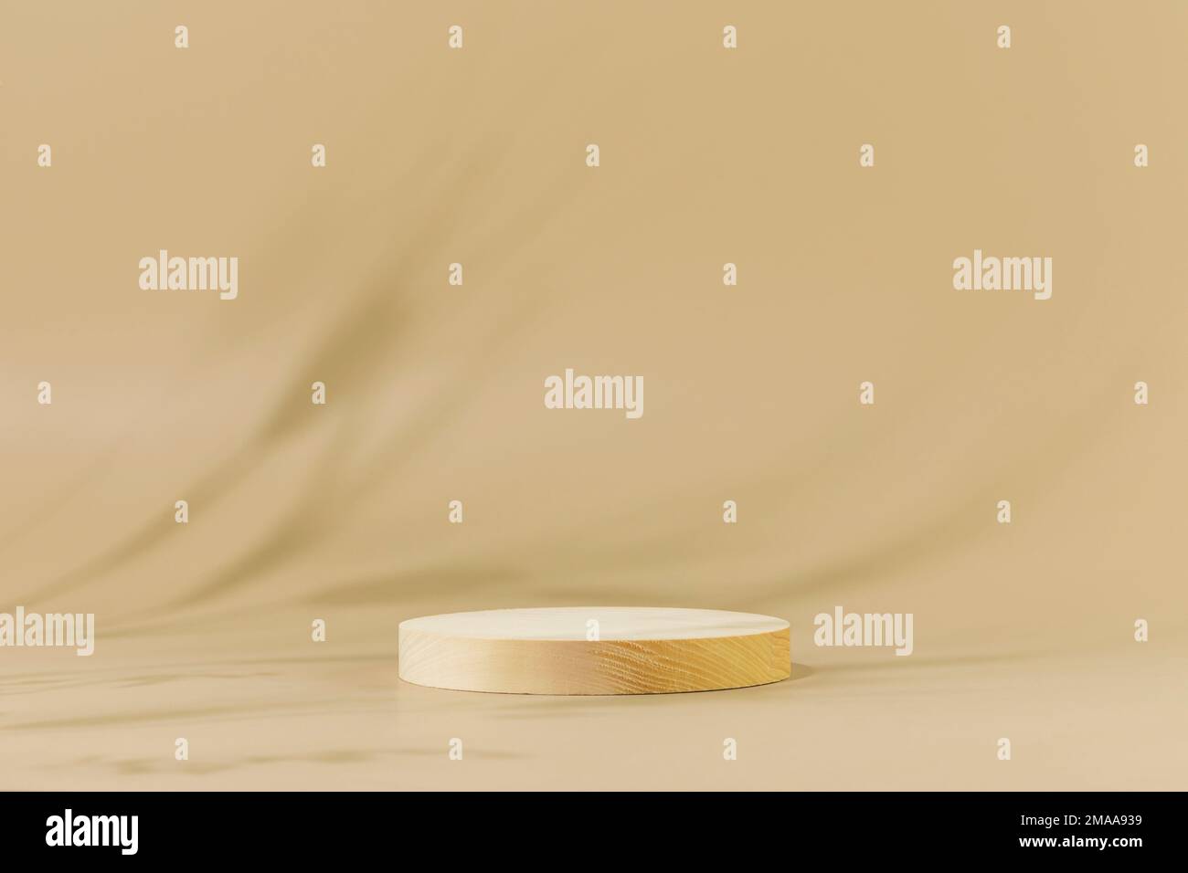 Round wooden podium with shadows of rye and wheat. Empty product display on natural beige background for presentation organic beauty products. Scene s Stock Photo