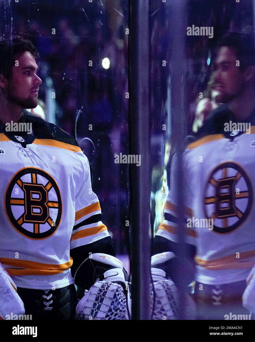 Boston Bruins goaltender Kyle Keyser is reflected by the glass during the national anthem before the teams preseason NHL hockey game against the New York Rangers, Wednesday, Oct
