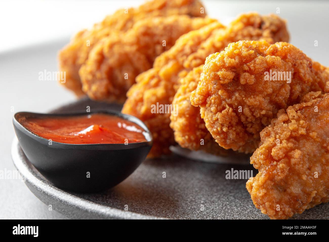 Kurkuri paneer snacks or Crispy Cottage Cheese Bars, served with tomato
