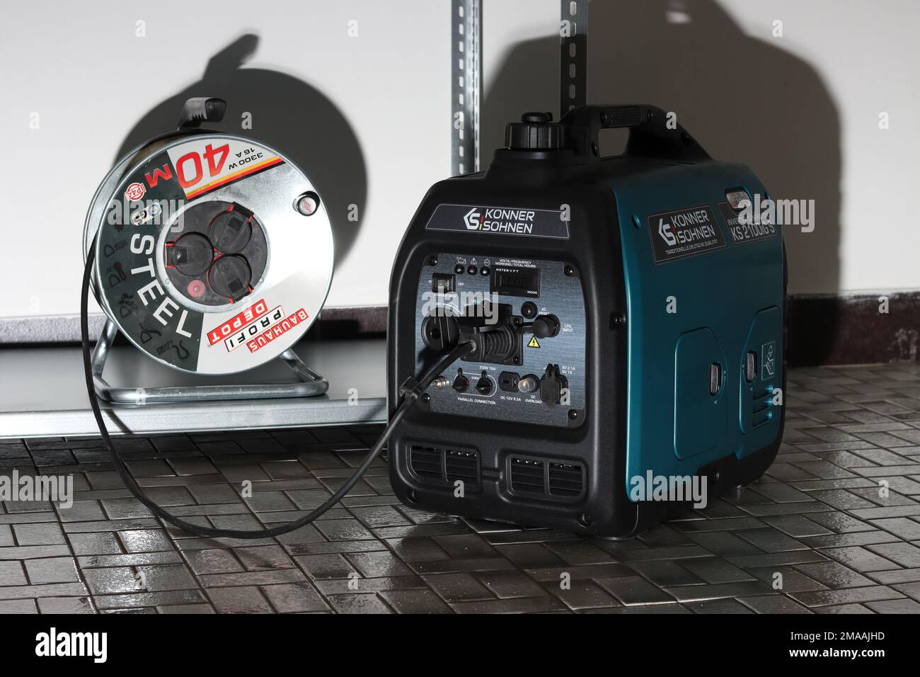 A portable gasoline powered generator with a cable drum Stock Photo - Alamy