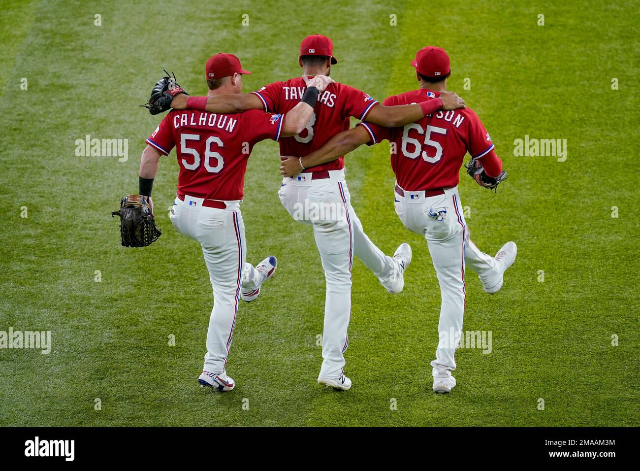 Texas Rangers' Kole Calhoun (56), Leody Taveras (3) and Bubba Thompson (65)  celebrate the team's 3-2 win in the second baseball game of a doubleheader  against the New York Yankees in Arlington