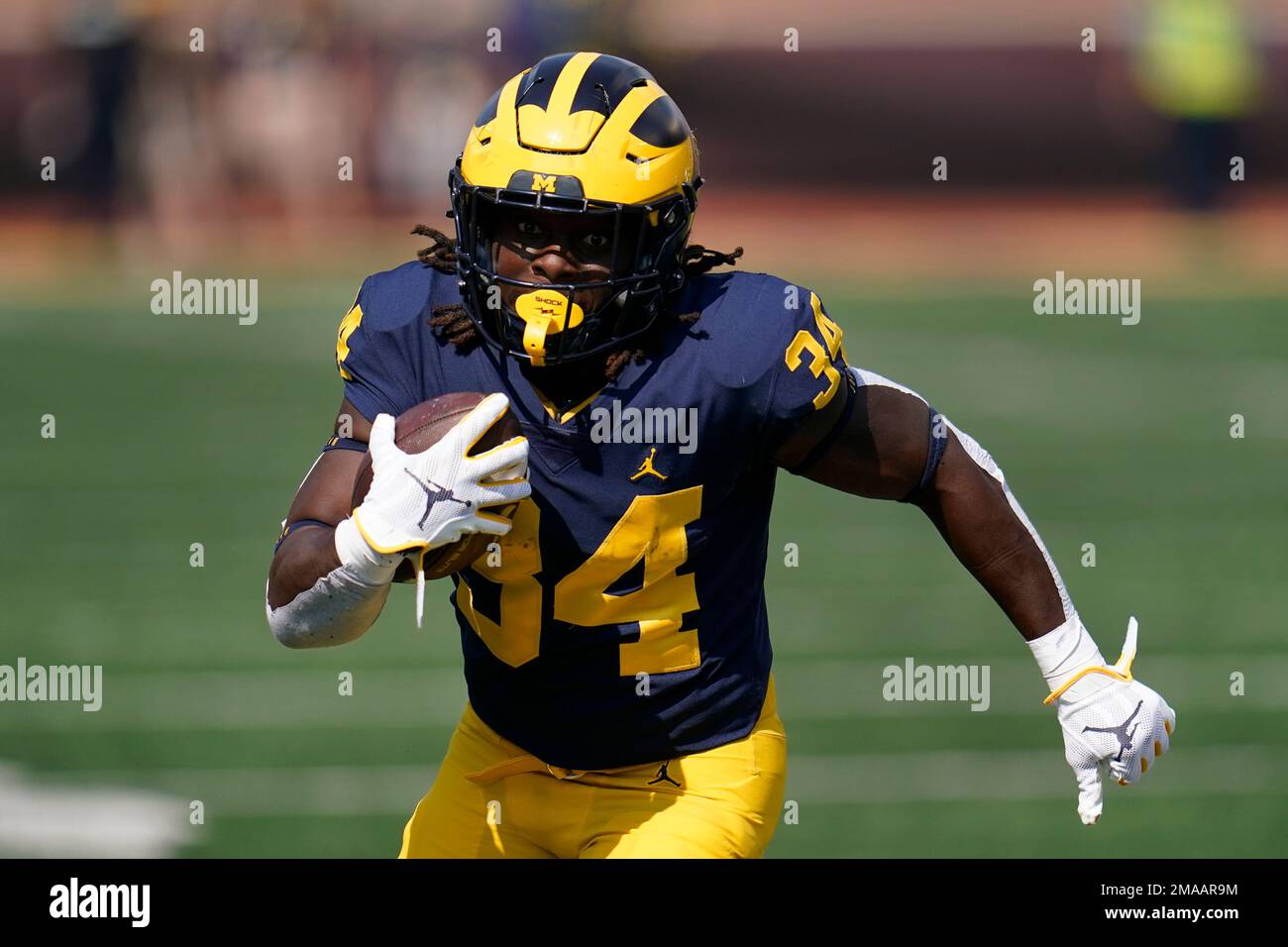 Michigan running back Leon Franklin (34) runs for a 20-yard touchdown  reception in the second half of an NCAA college football game against  Connecticut in Ann Arbor, Mich., Saturday, Sept. 17, 2022. (