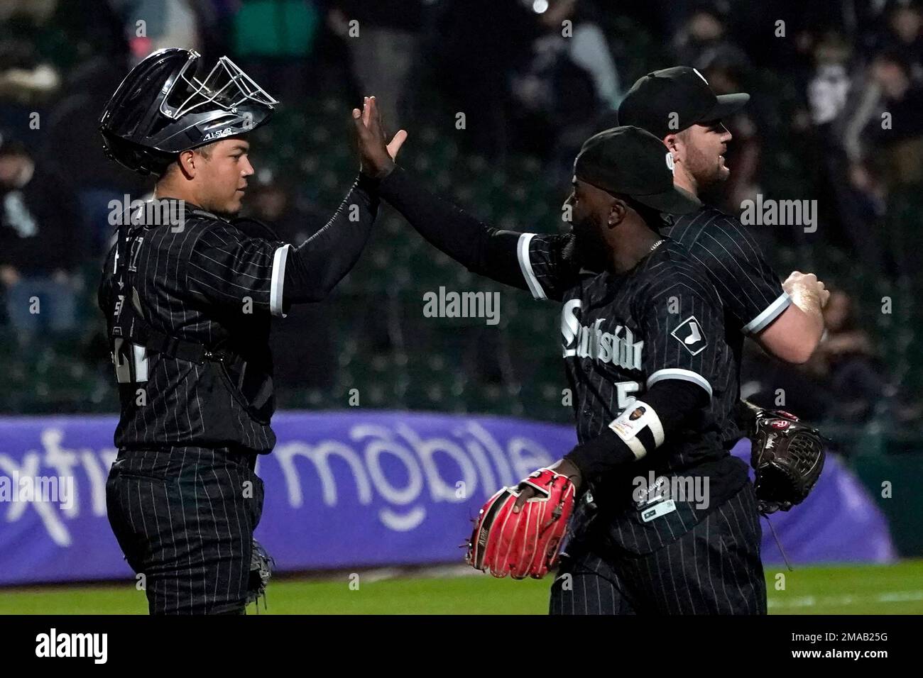 Chicago White Sox catcher Carlos Perez and second baseman Josh Harrison  celebrate the team's 3-2 win over the Minnesota Twins after a baseball game  Monday, Oct. 3, 2022, in Chicago. (AP Photo/Charles
