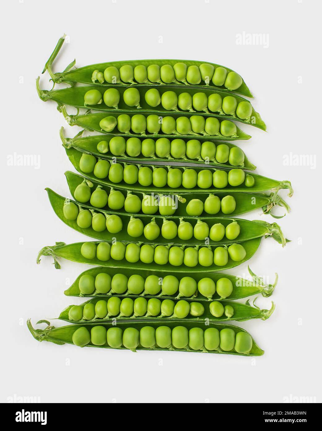 Young green peas in pods on a white background Stock Photo Alamy