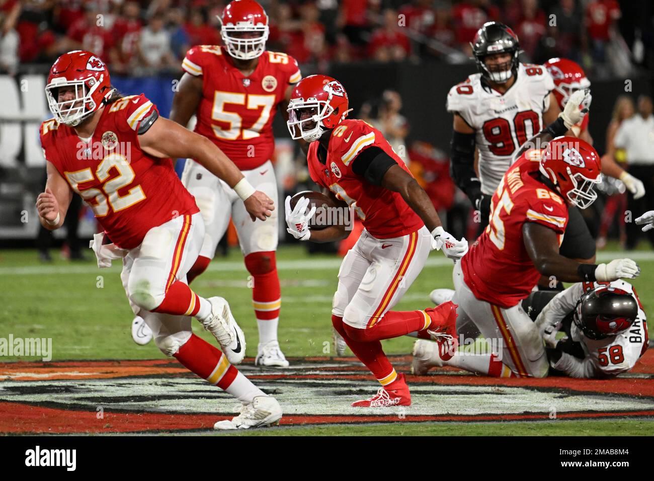Kansas City Chiefs center Creed Humphrey (52) leads wide receiver JuJu