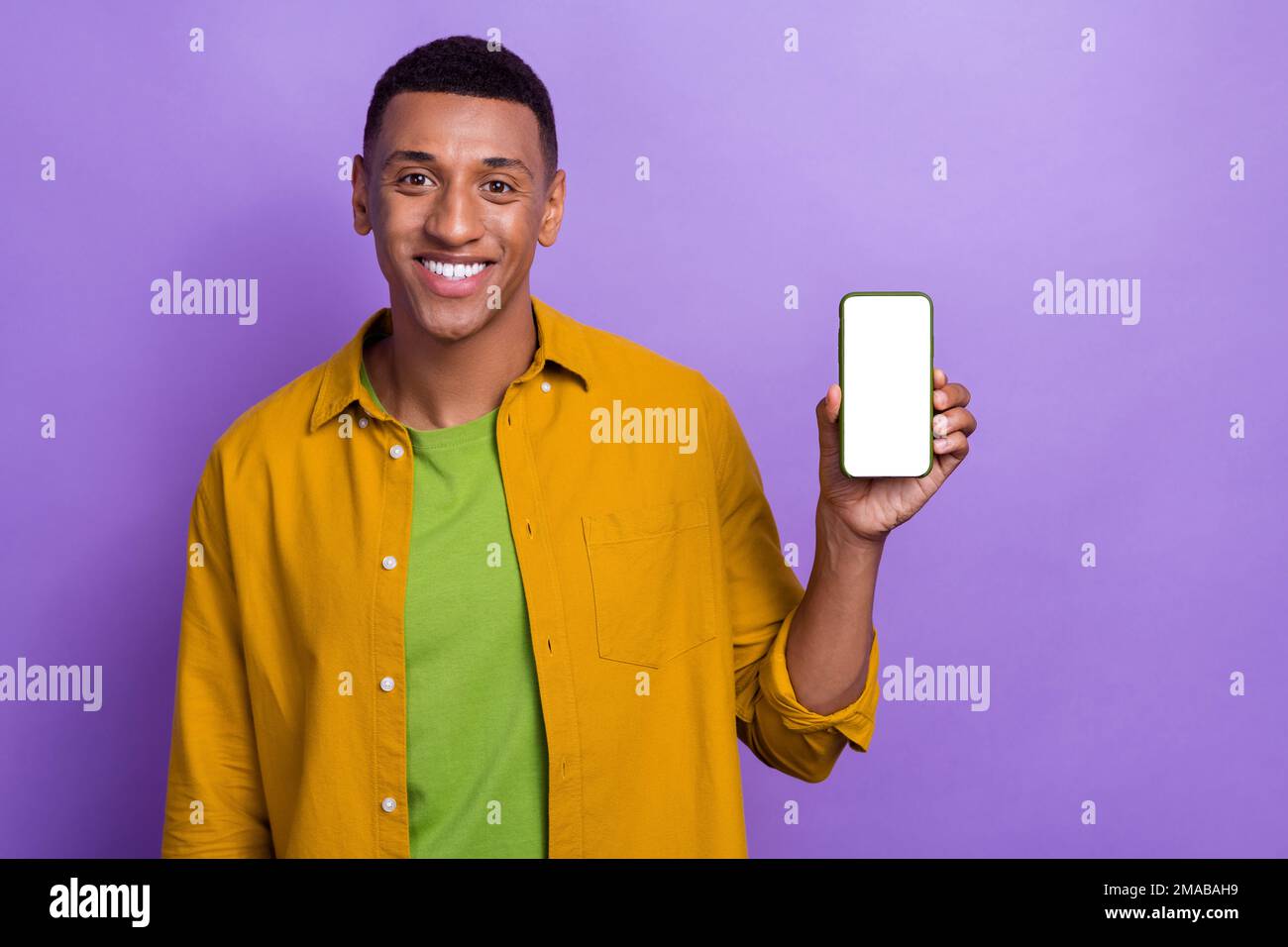 Photo of positive handsome guy toothy smile arm hold show empty space ...