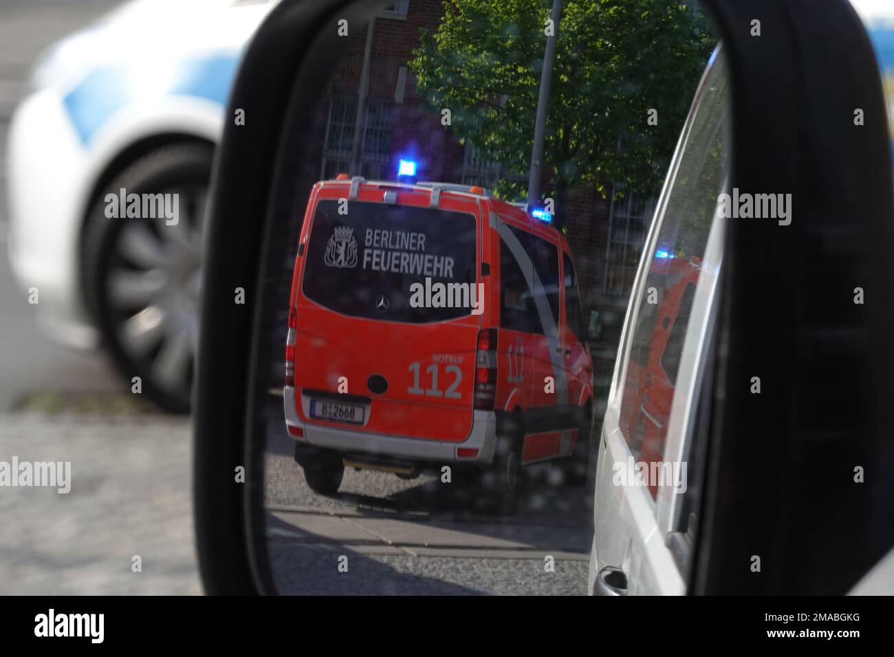 18.05.2022, Germany, , Berlin - Emergency ambulance of Berlin fire department reflected in the side mirror of a car. 00S220518D064CAROEX.JPG [MODEL RE Stock Photo
