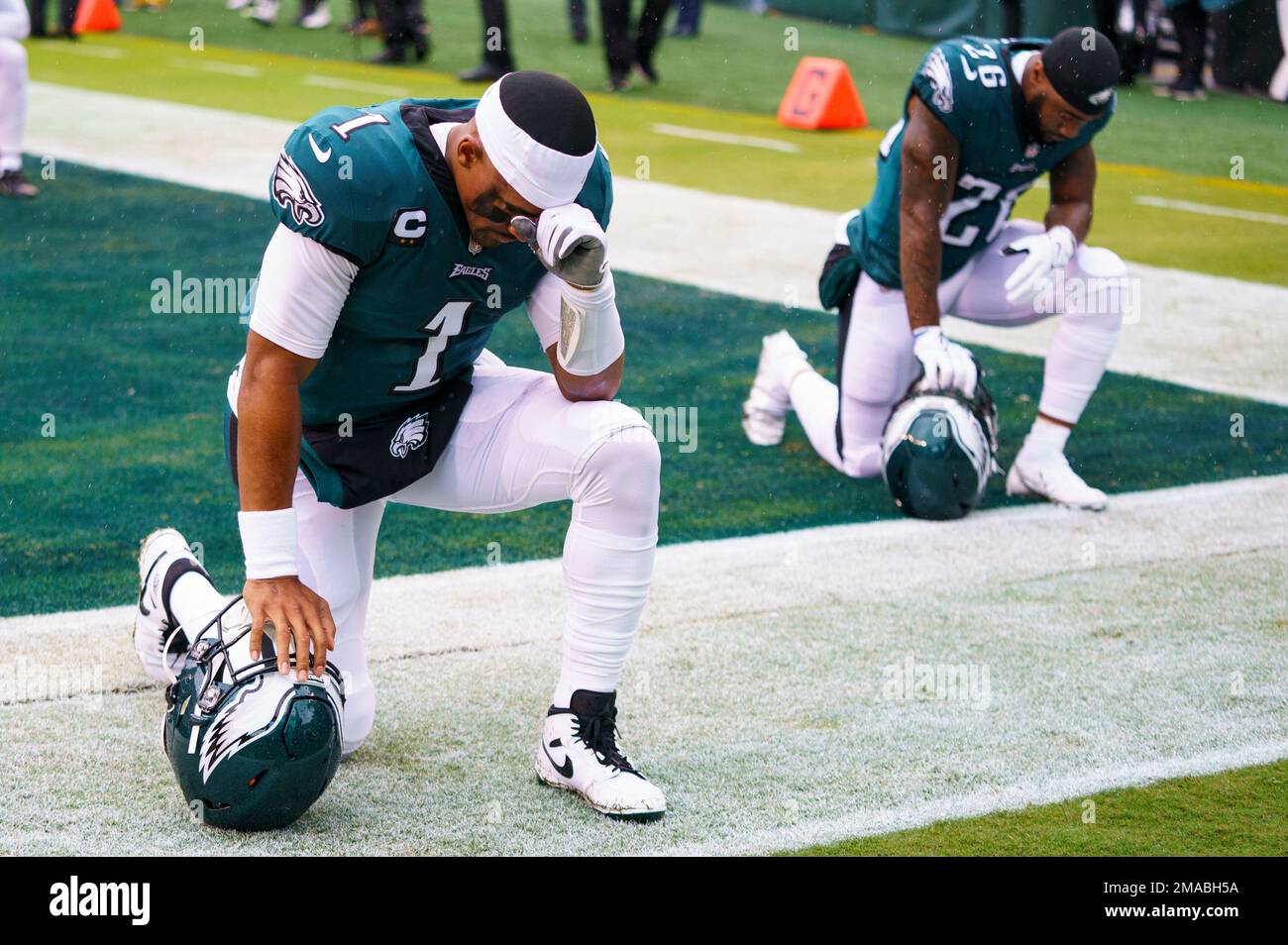 Philadelphia Eagles quarterbacks Jalen Hurts (1) kneels with running