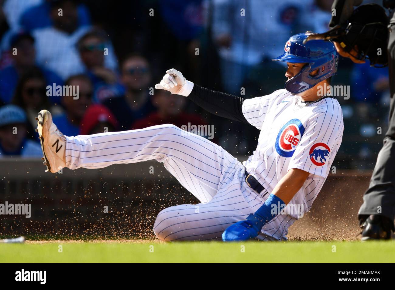 Chicago Cubs' Seiya Suzuki slides safely into home plate on a Nico Hoerner  sacrifice fly during the fourth inning of a baseball game against the  Cincinnati Reds, Sunday, Oct. 2, 2022, in