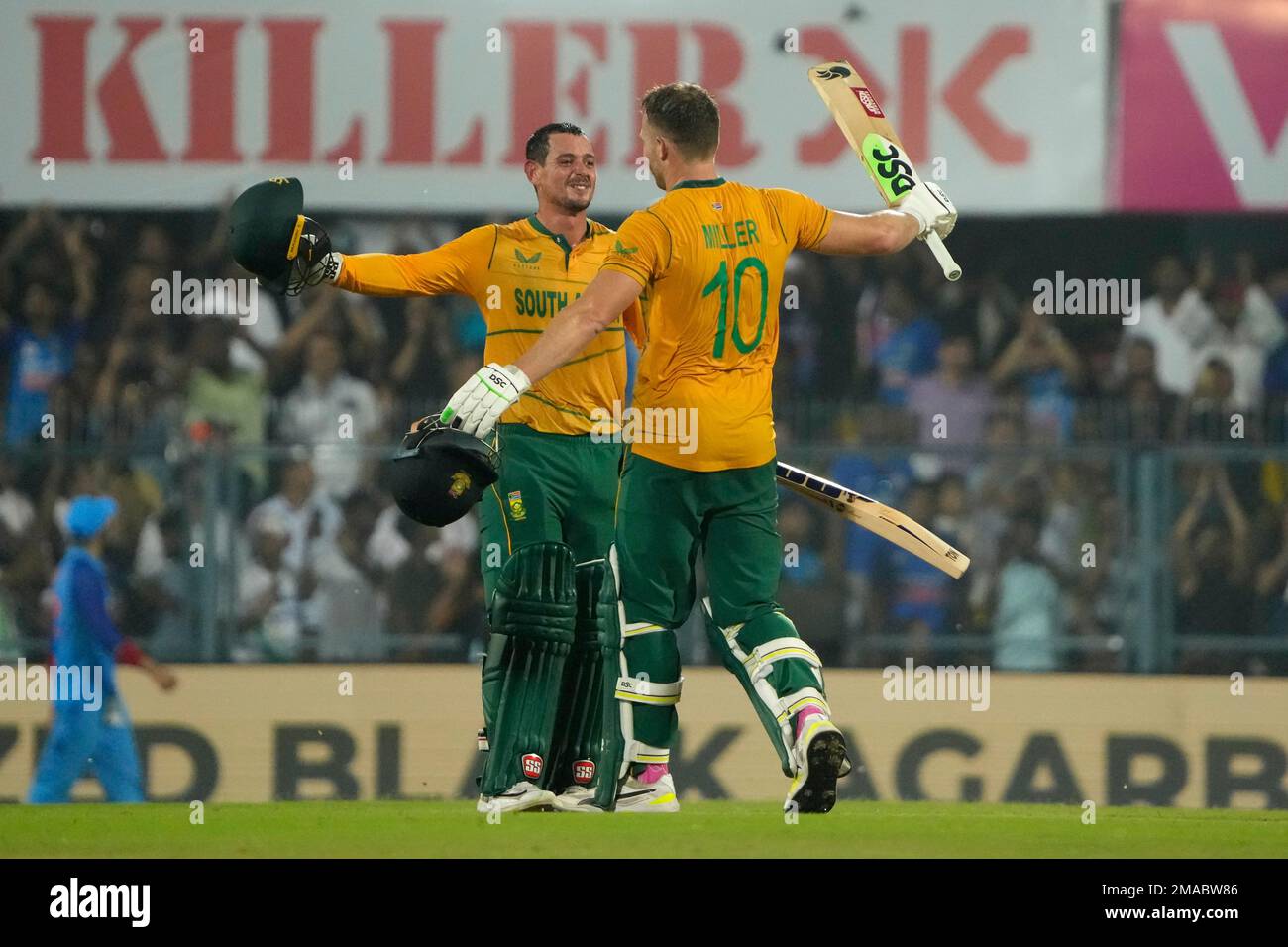 South Africas David Miller, right, celebrates with batting partner Quinton de Kock after scoring a century during the second T20 cricket match between India and South Africa, in Guwahati, India, Sunday, Oct.