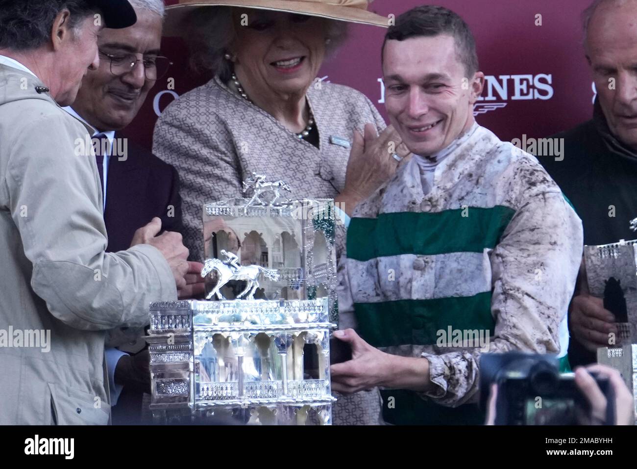 British jockey Luke Morris holds his trophy after winning the Qatar