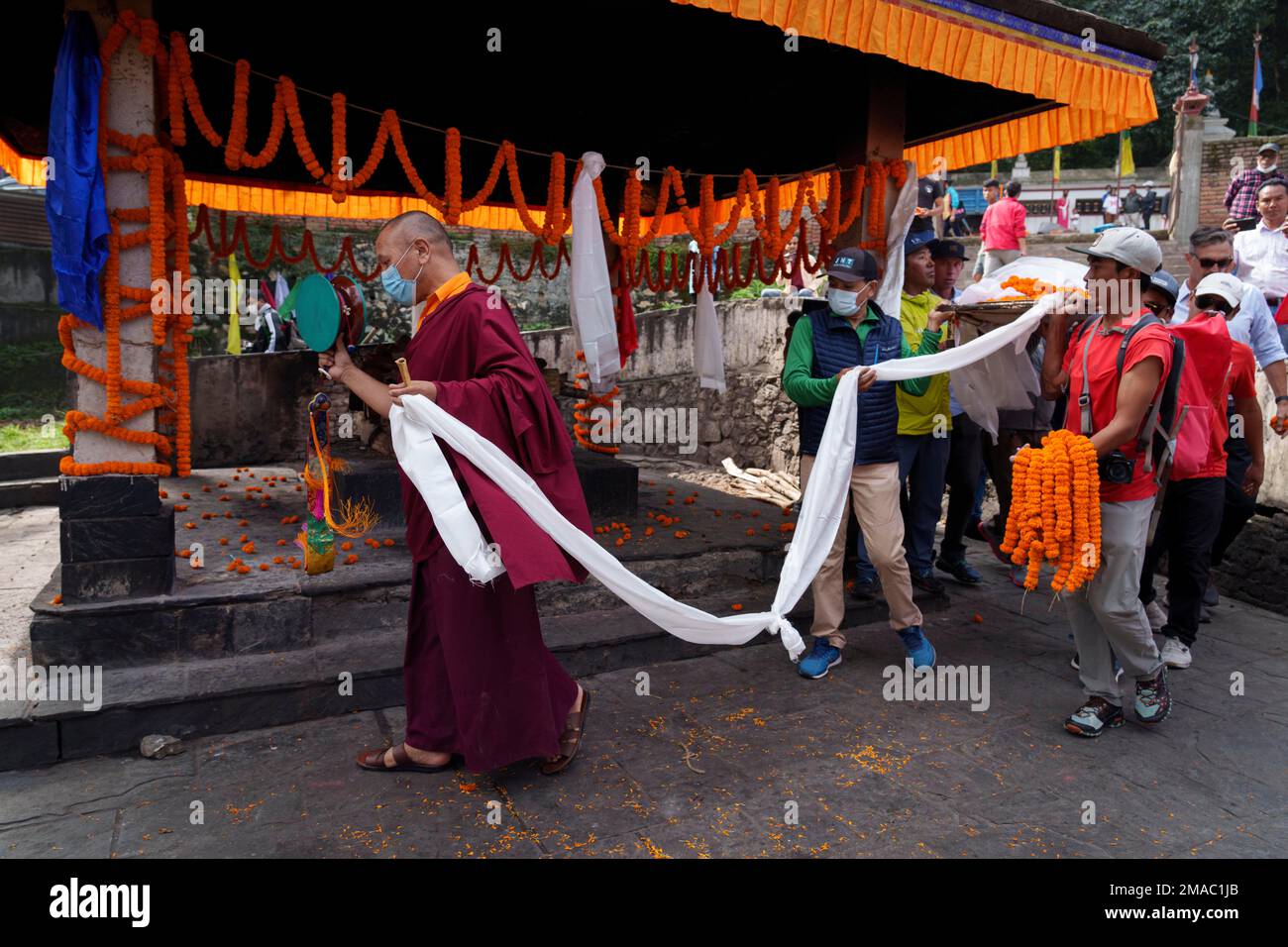 Buddhist monks perform rituals during the funeral of famed American ...