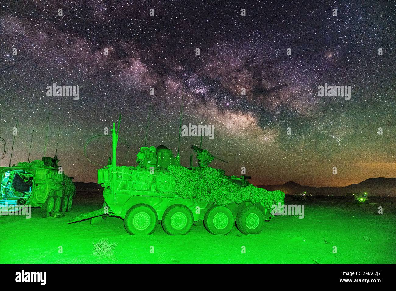 A U.S. Army Stryker assigned to Col. Kevin Bradley, commander of 3d Cavalry Regiment, is parked at a remote location of the National Training Center during a moonless, open sky where the milky way was visible May 24, 2022. Additionally, unmanned aircraft circled the vicinity to monitor for threats and intelligence from the sky. Stock Photo
