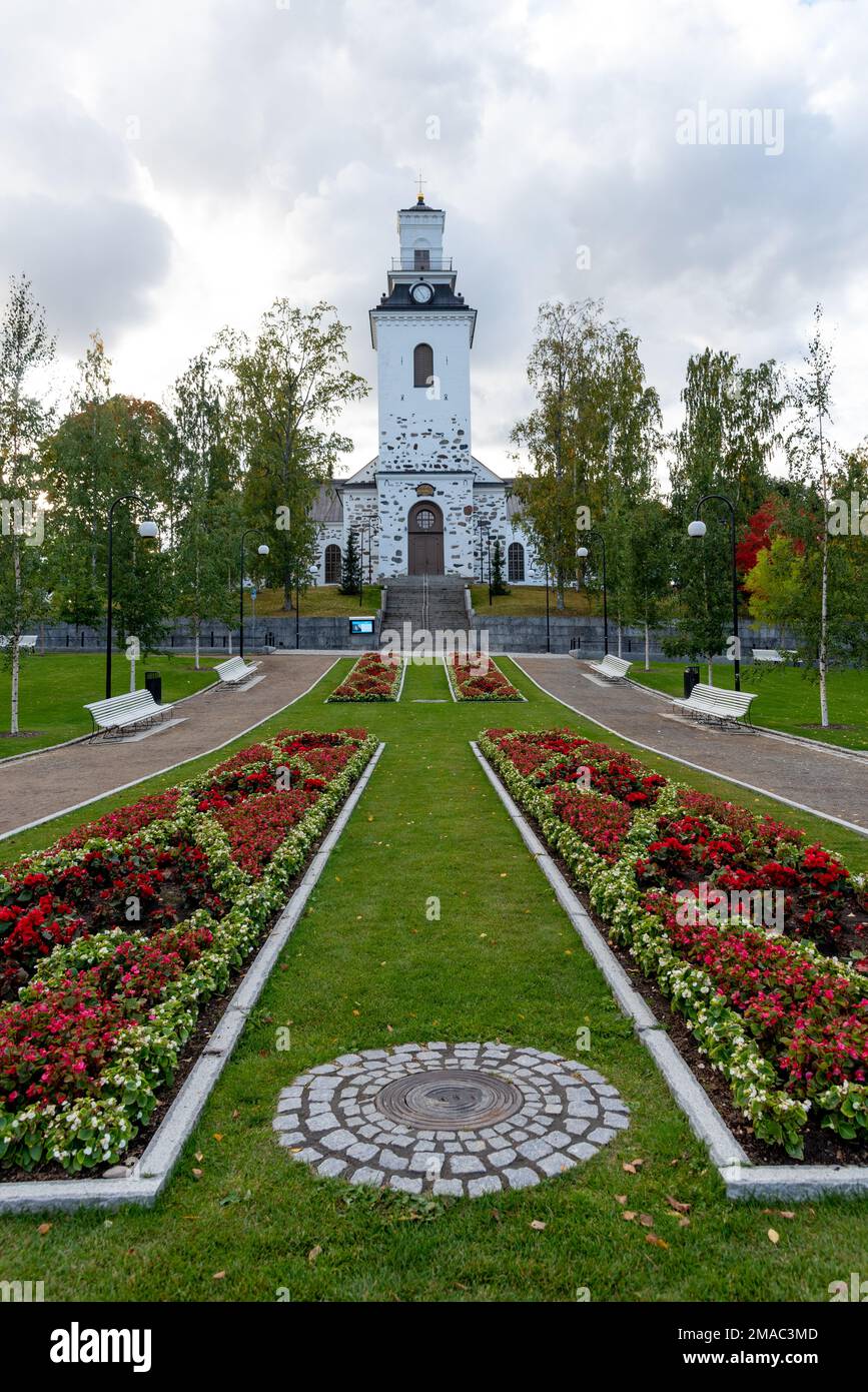 Green blooming garden in autumn in the park of evangelical neoclassical style Lutheran cathedral of Kuopio Finland Stock Photo