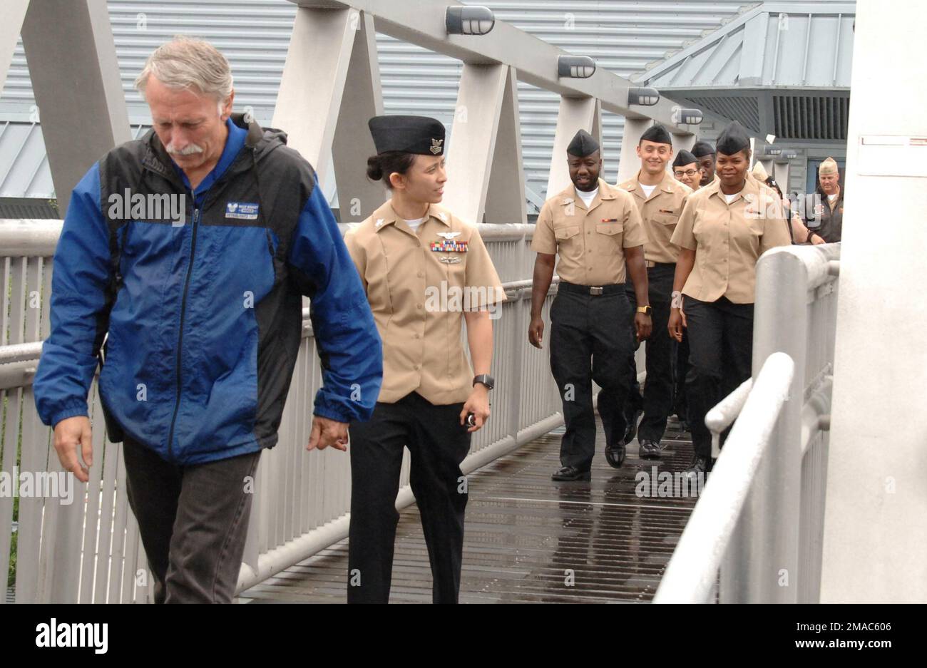 ABH1(AW/SW/IW) Darlene Rule, assigned to USS Wash (LHD-1), follows Tom Dandes, Military Ceremonies Coordinator at the Hampton Roads Naval Museum as they cross the gangway to board the Battleship Wisconsin. Stock Photo