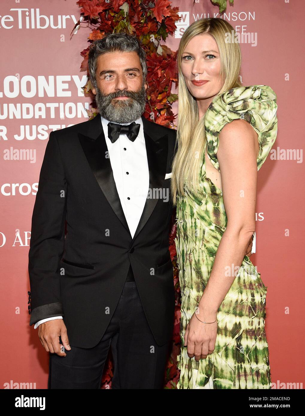 Oscar Isaac, left, and wife Elvira Lind attend the Clooney Foundation ...