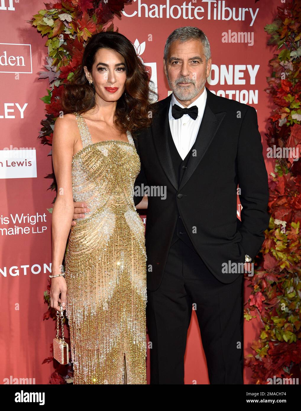Clooney, right, and wife Amal Clooney attend the Clooney