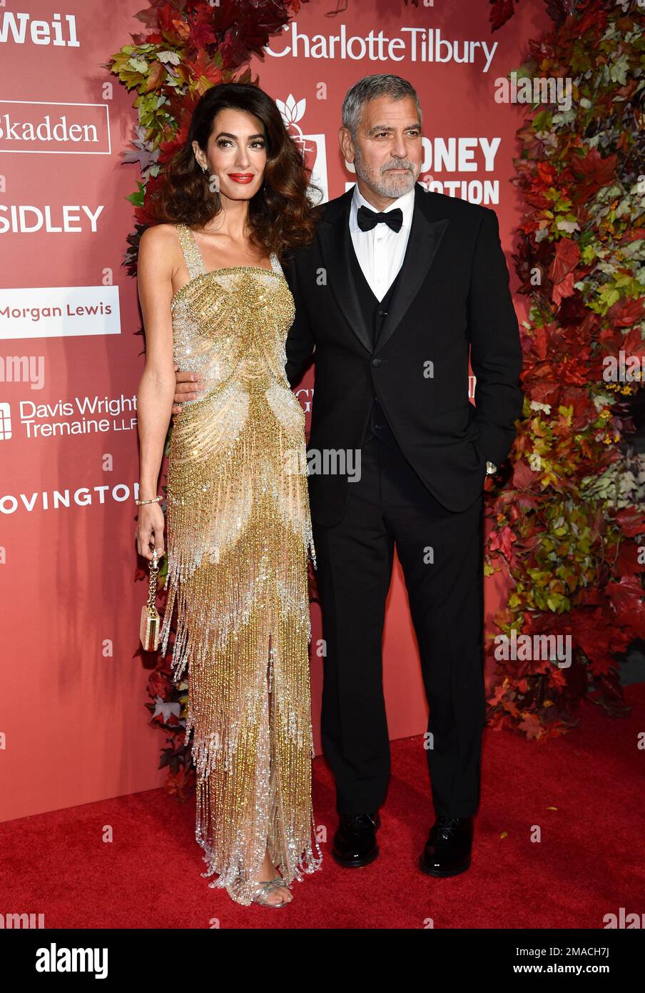 Clooney, right, and wife Amal Clooney attend the Clooney