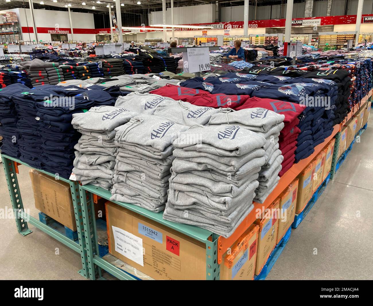 Hold For Biz—Retail Sales—Shoppers peruse stacks of clothing on display ...