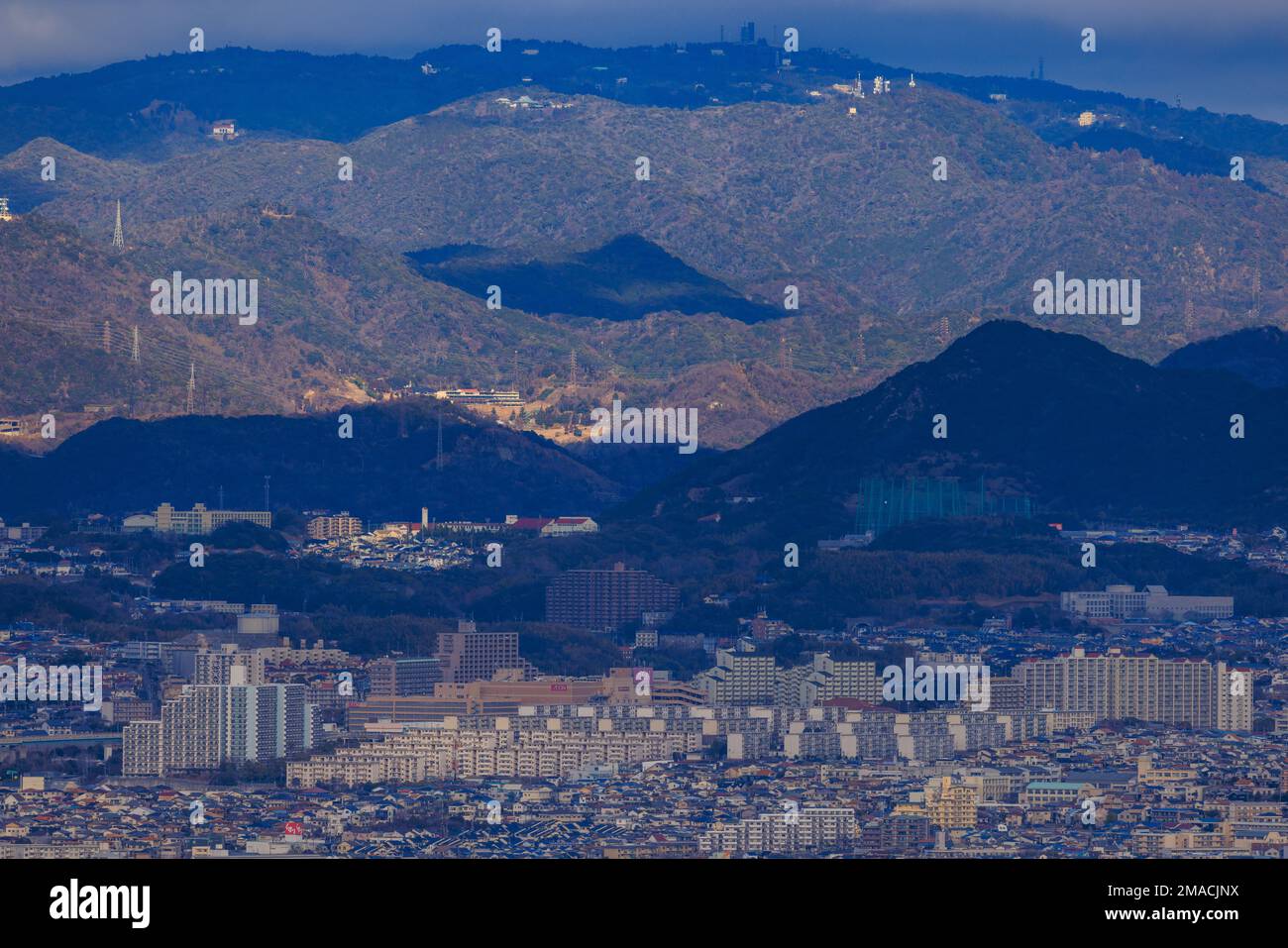 Large Residential Apartment Complex between Sprawling City and Mountains Stock Photo