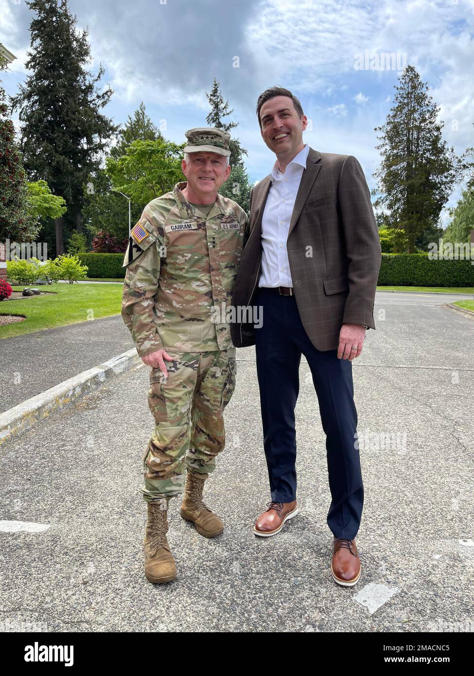 Lt. Gen. Douglas Gabram, commander of U.S. Army Installation Management Command and Josh Jacobs, vice president of Clean Energy Strategy with Puget Sound Energy pose for a picture during the Energy Check presentation on Joint Base Lewis-McChord May 25. Stock Photo