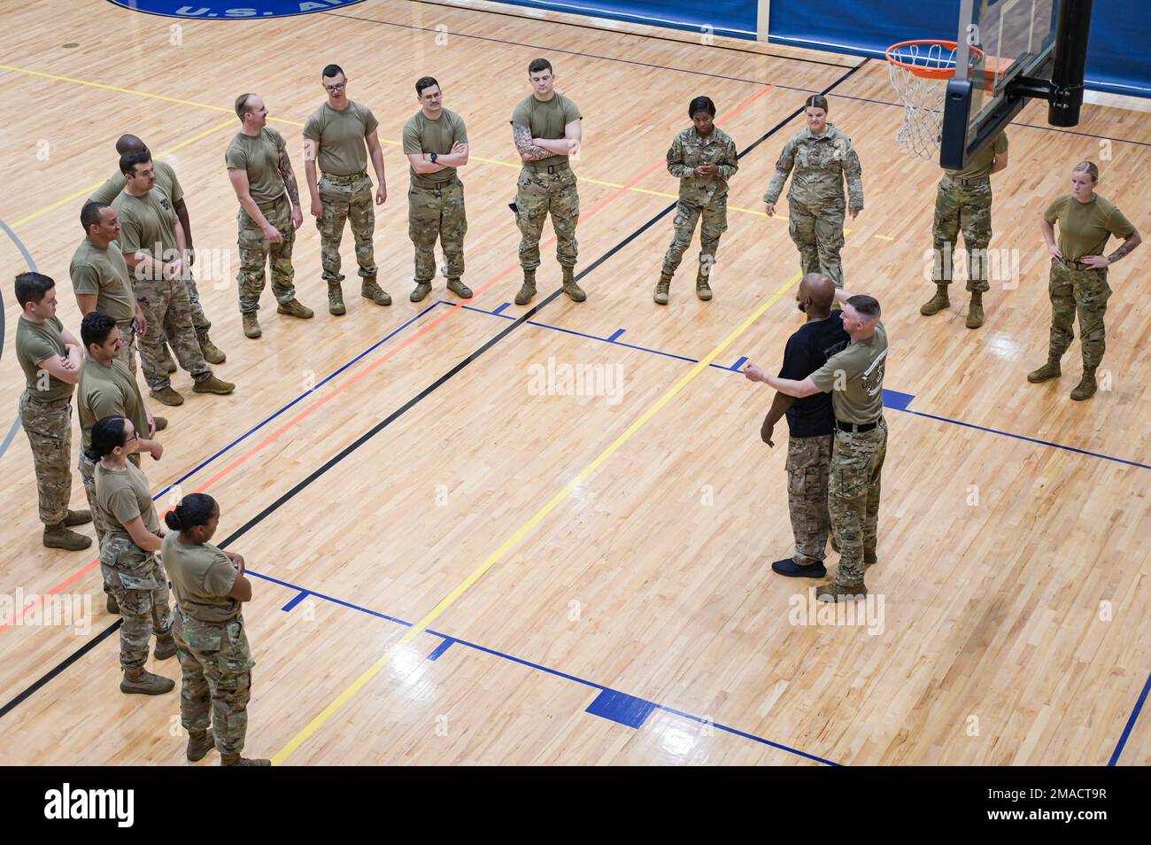 Airmen from the 23rd Security Forces Squadron circle around Bobby Cumby ...
