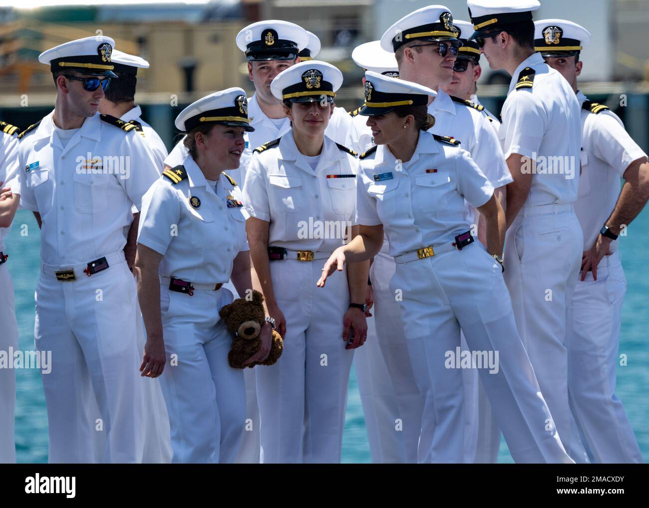 220525-N-LN285-3455 JOINT BASE PEARL HARBOR-HICKAM (May 25, 2022) -- Lt. Andrea Weiss, from Natchitoches, La., Lt.j.g. Sabella Norton, from Merritt Island, Fla., and Lt.j.g. Delaney Bolton, from St. Augustine, Fla., assigned to the Virginia-class fast-attack submarine USS North Carolina (SSN 777) gather topside after the boat returns to Joint Base Pearl Harbor-Hickam from deployment in the 7th Fleet area of responsibility. North Carolina performed a full spectrum of operations, including anti-submarine and anti-surface warfare, during the extended seven-month, Indo-Pacific deployment. Stock Photo