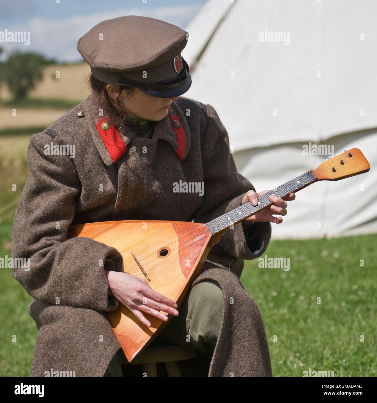 A Soldier of the Imperial Russian Army  plays a traditional style balalaika Stock Photo