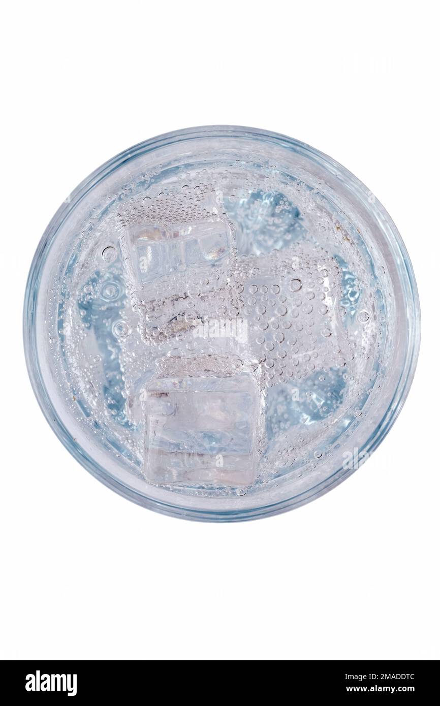refreshing soft tonic or mineral water with ice in a glass, top view ...