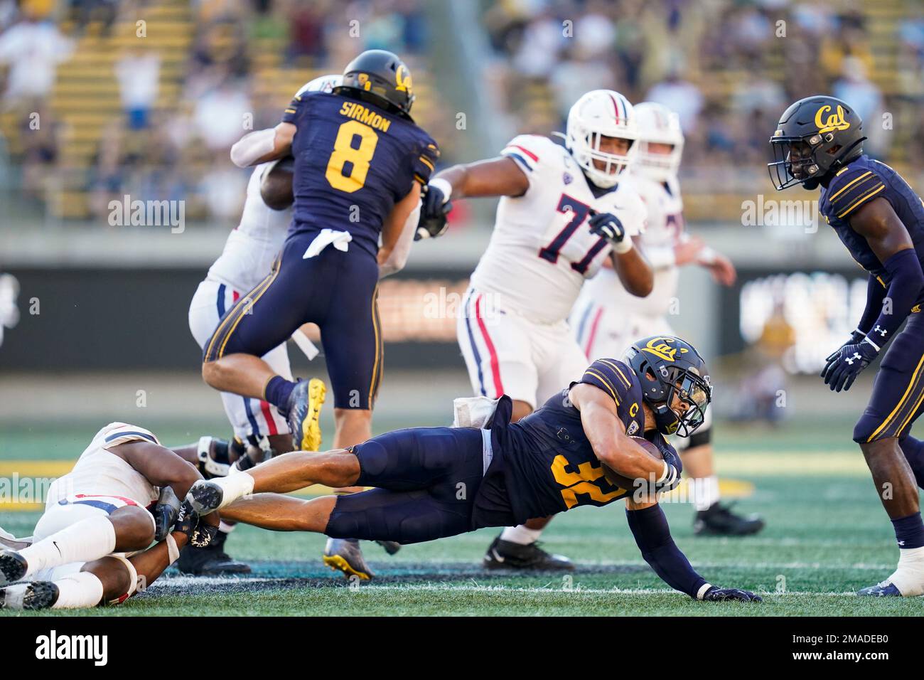 California safety Daniel Scott (32) is tackled after intercepting