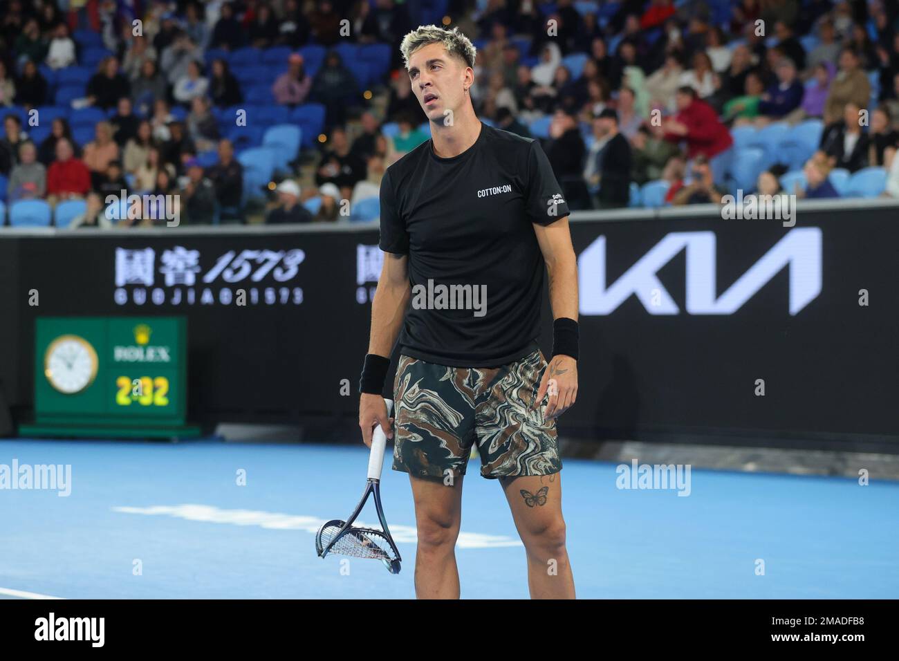 Thanasi Kokkinakis of Australia smashes his racquet during round 2