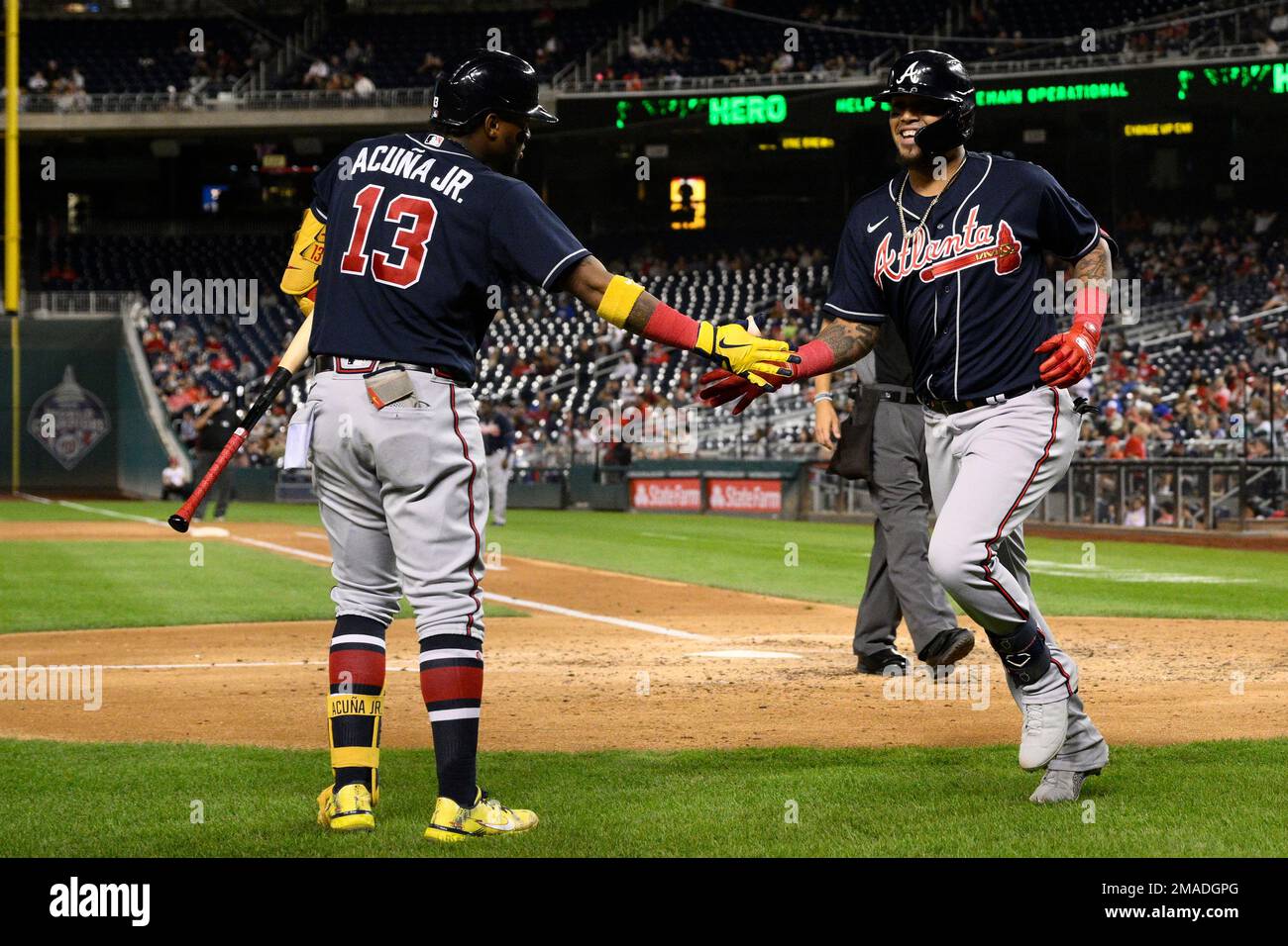 Atlanta Braves' Orlando Arcia, right, celebrates with Ronald Acuna Jr.  (13)after hitting a two-run home run during the sixth inning of a baseball  game against the Washington Nationals, Monday, Sept. 26, 2022