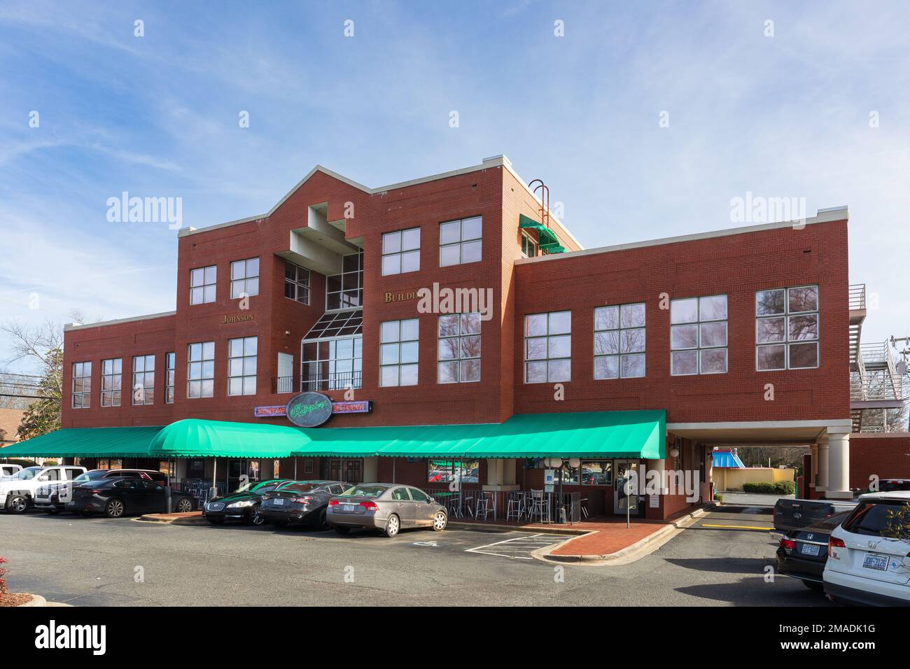 MATTHEWS, NC, USA-15 JANUARY 2023: Kristopher's Sports Bar and Restaurant, in the Johnson Building on Trade Street.  Building, sign and parking lot. Stock Photo
