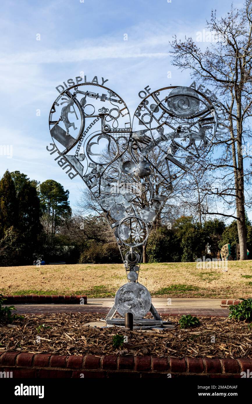 MATTHEWS, NC, USA-15 JANUARY 2023: A heart-shaped steel fabricated sculpture in public park called 'Public Display of Affection'.  Trade Street.  Sunn Stock Photo