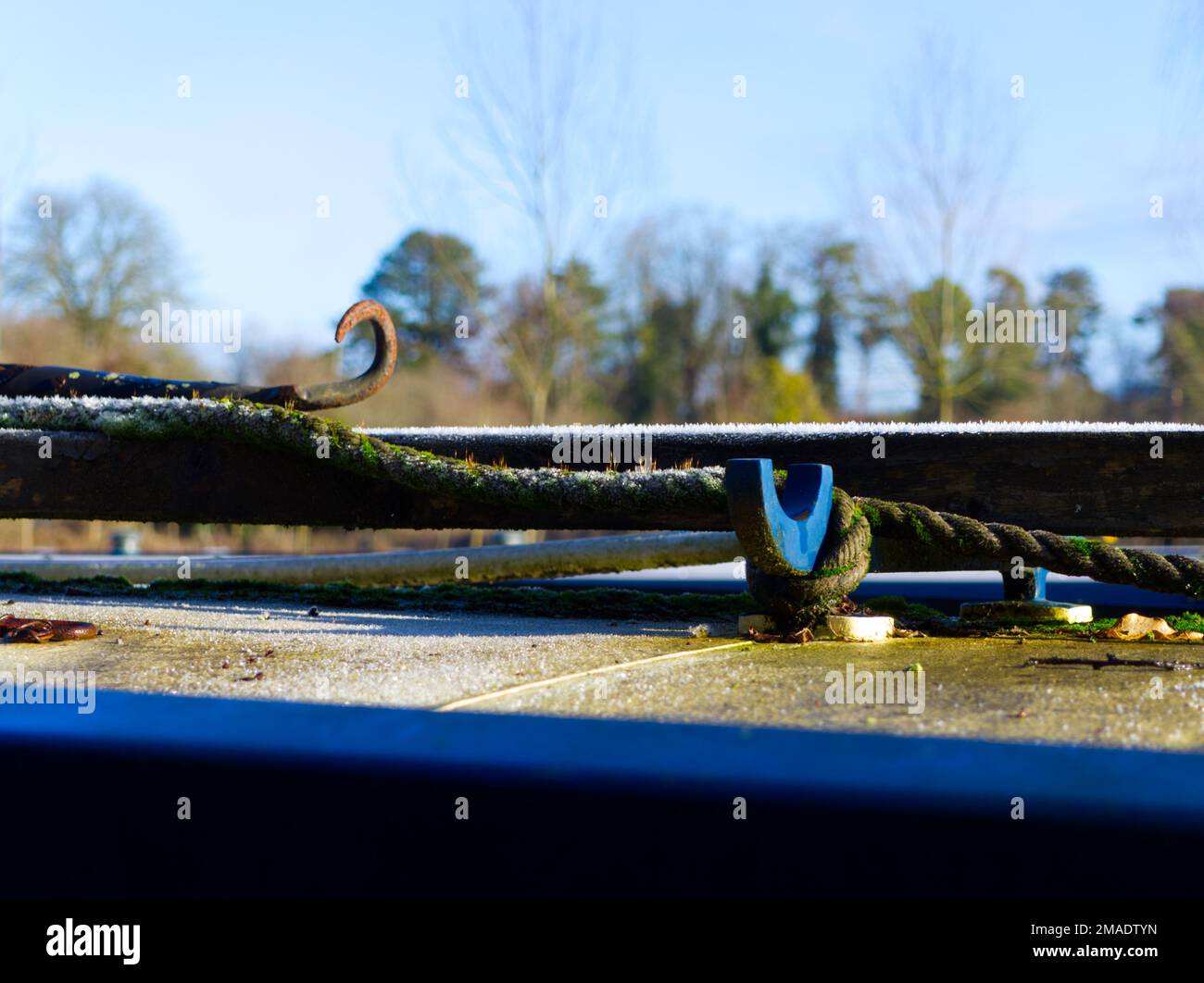 Icy rope and hook on roof of canal boat at Aynho Stock Photo