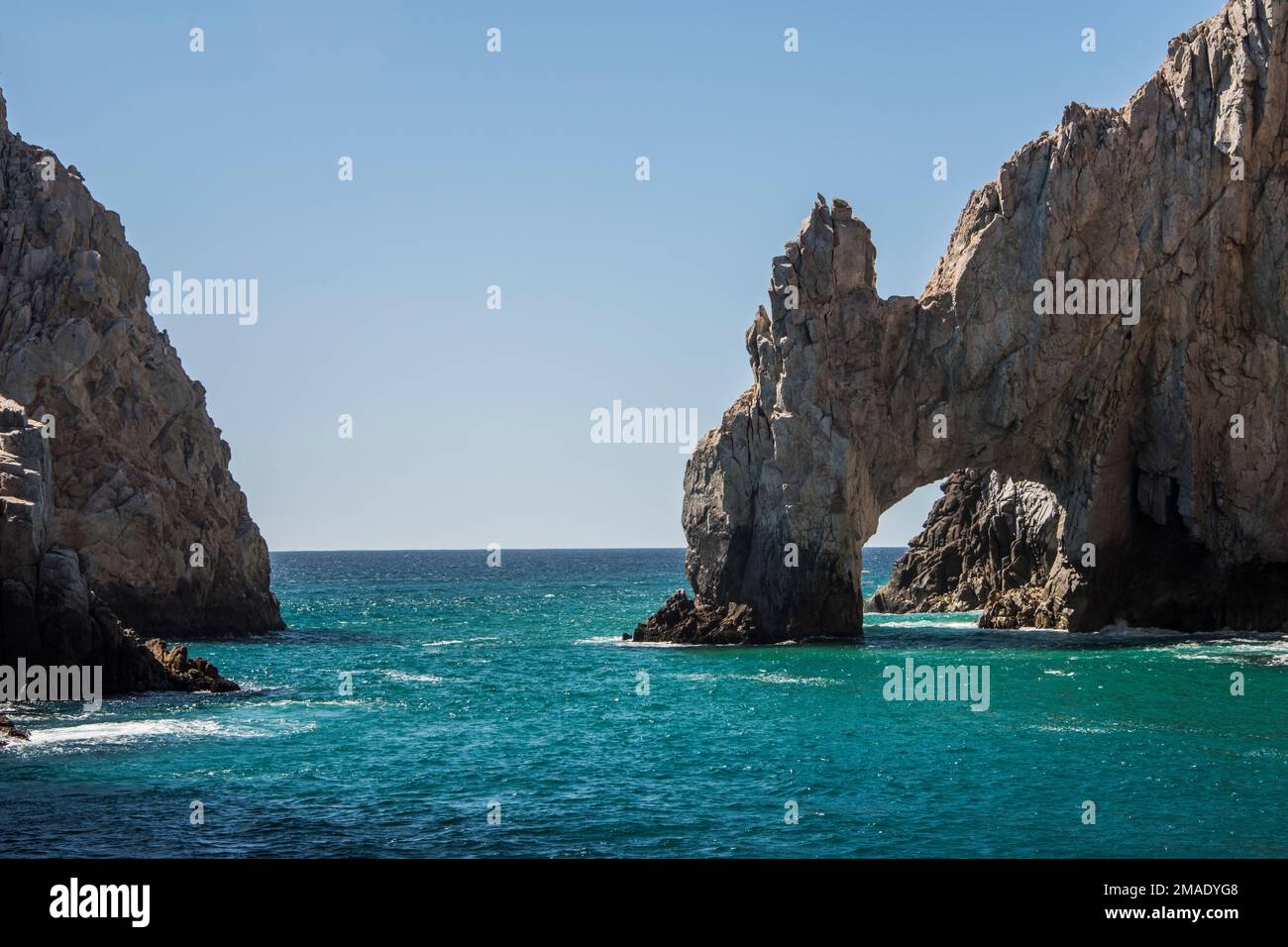 The Cabo Arch is perhaps the most famous landmark in Cabo San Lucas, Mexican Riviera, Mexico. It is only reachable via boat and sits at Land's End. Stock Photo