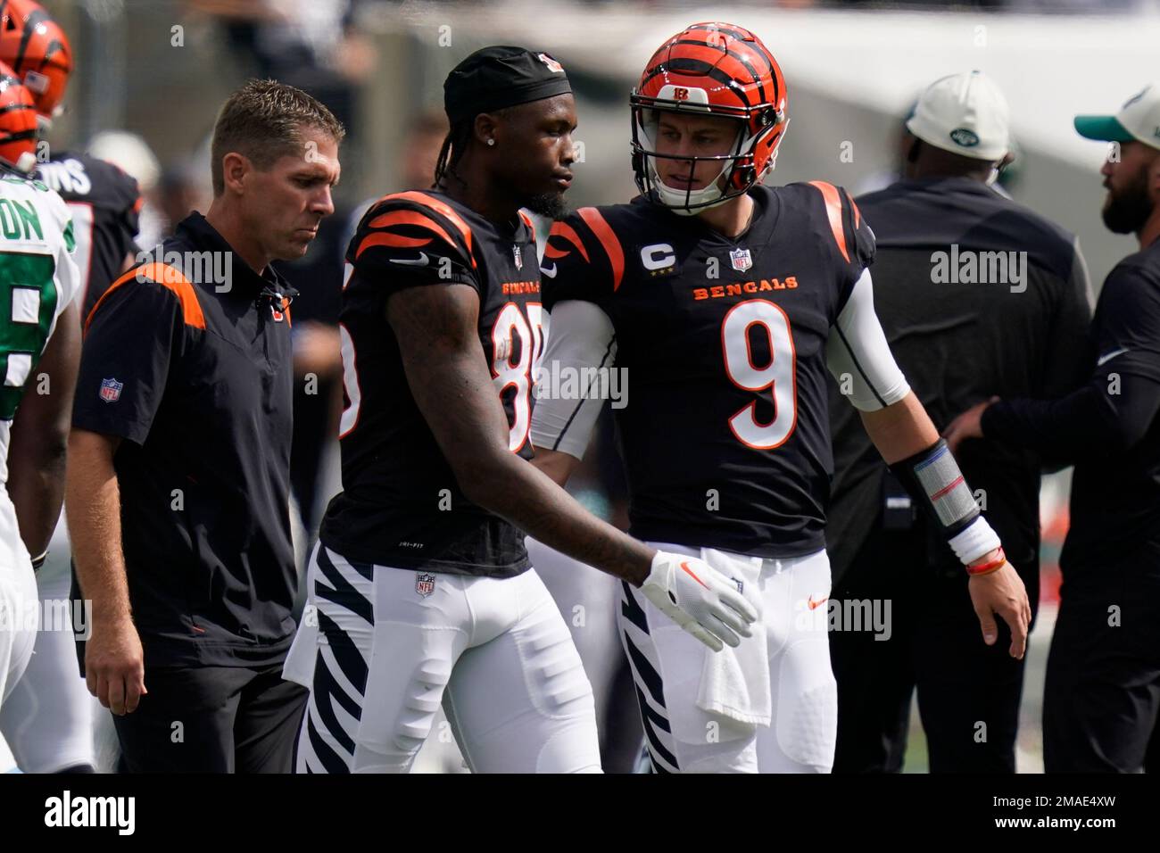 Cincinnati Bengals quarterback Joe Burrow (9) checks on Tee Higgins (85)  after Higgins was hurt on a play during the first half of an NFL football  game against the New York Jets