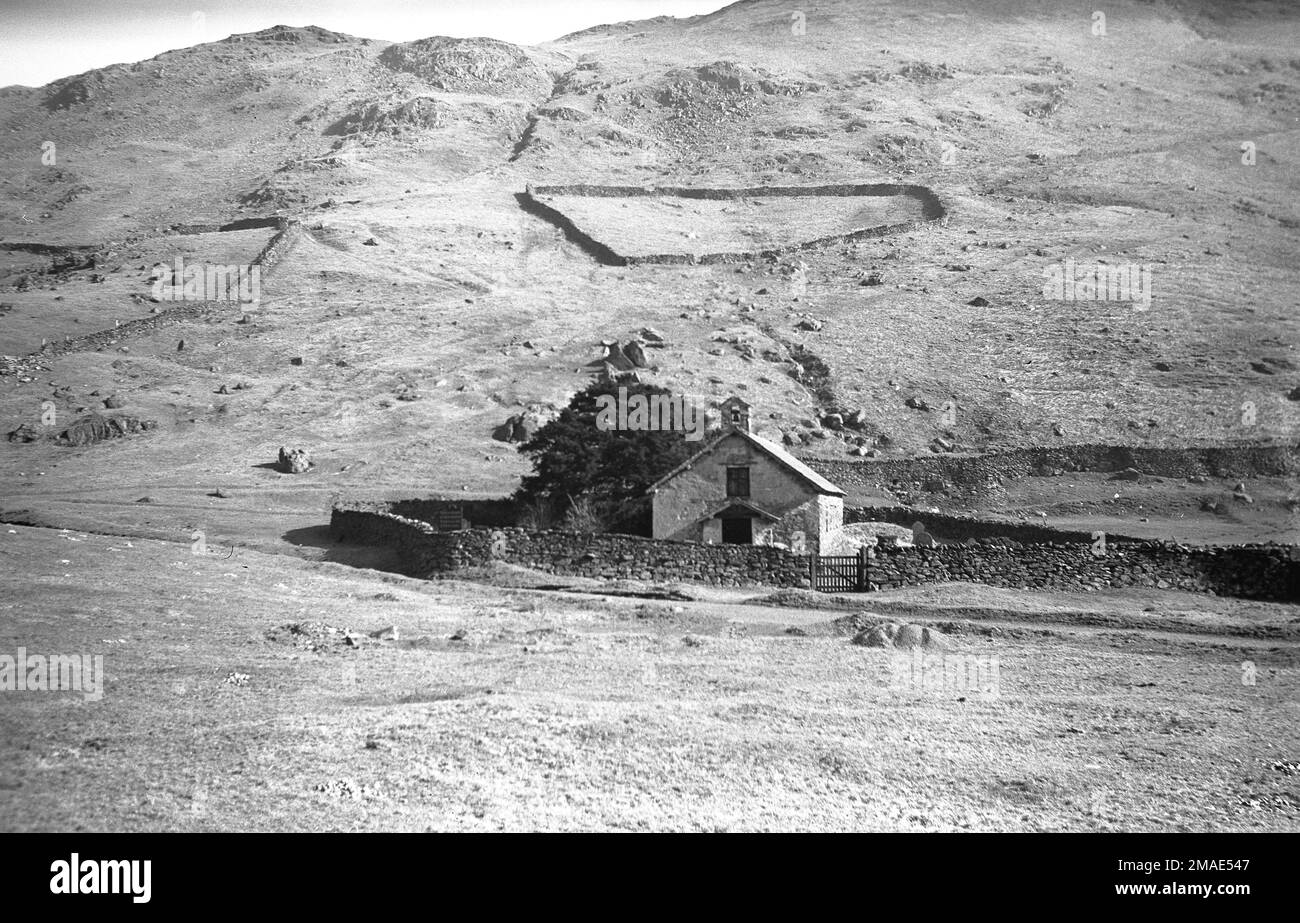1951, historical view of St Martin's Church, a small old church located in a valley below hillside at Martindale, Lake District, Cumbria, England, UK. Stock Photo
