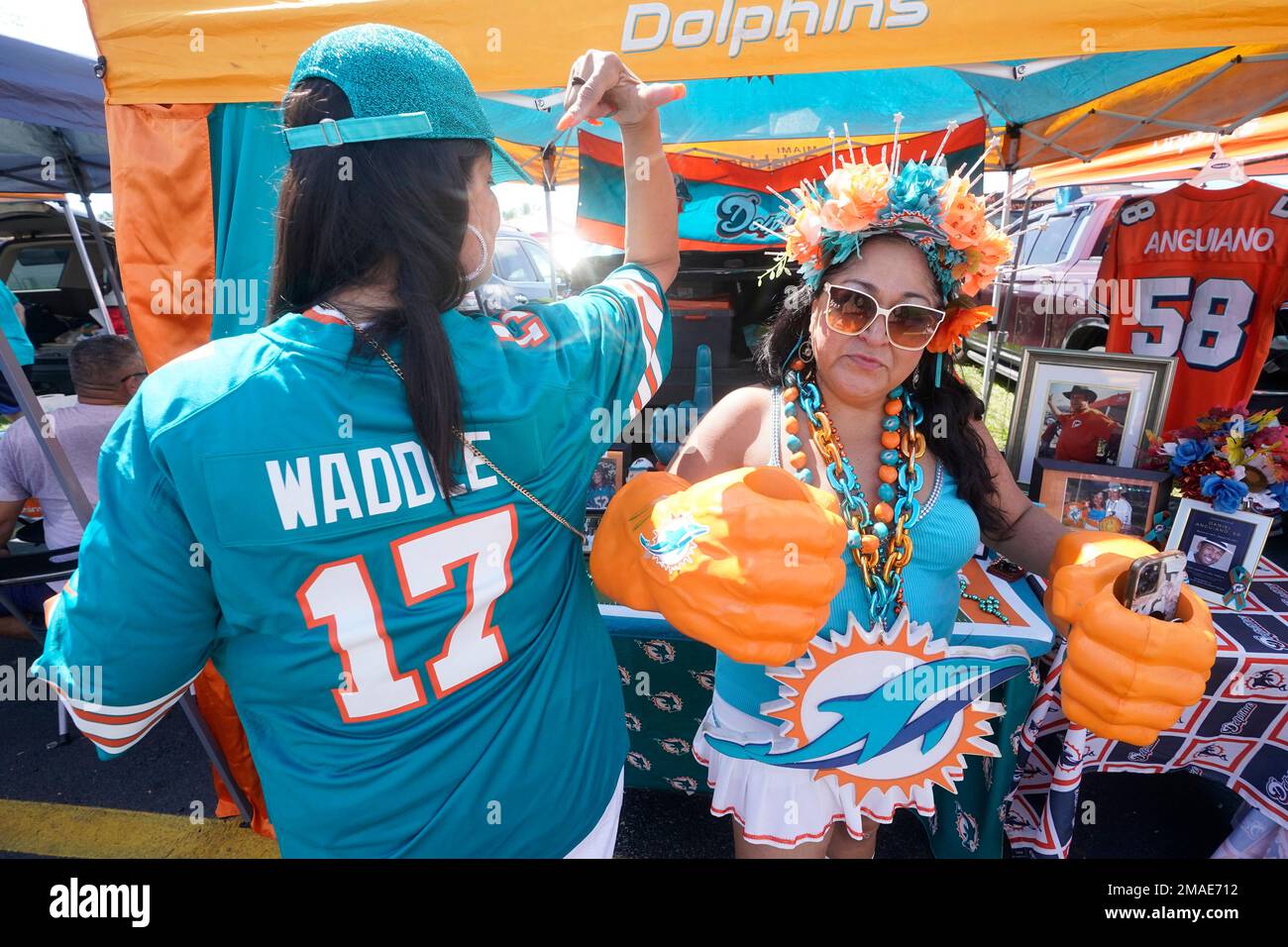 Miami Dolphins fans pose for a photo as they tailgate before the start of  an NFL football game between the Miami Dolphins and the Oakland Raiders,  Sunday, Sept. 16, 2012 in Miami.