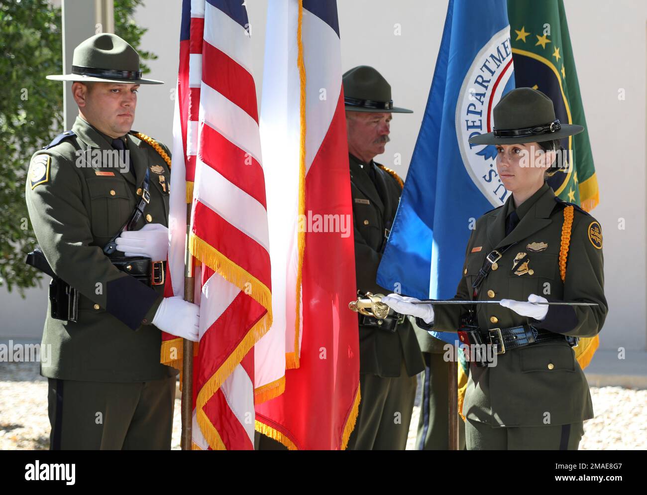 Agent Shay Miller holds a ceremonial sword used to cut a cake during